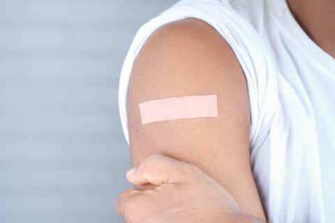 Young boy's Arm with vaccination plaster