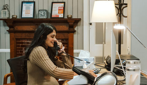 A team member taking a call at Stonegate Medical Clinic
